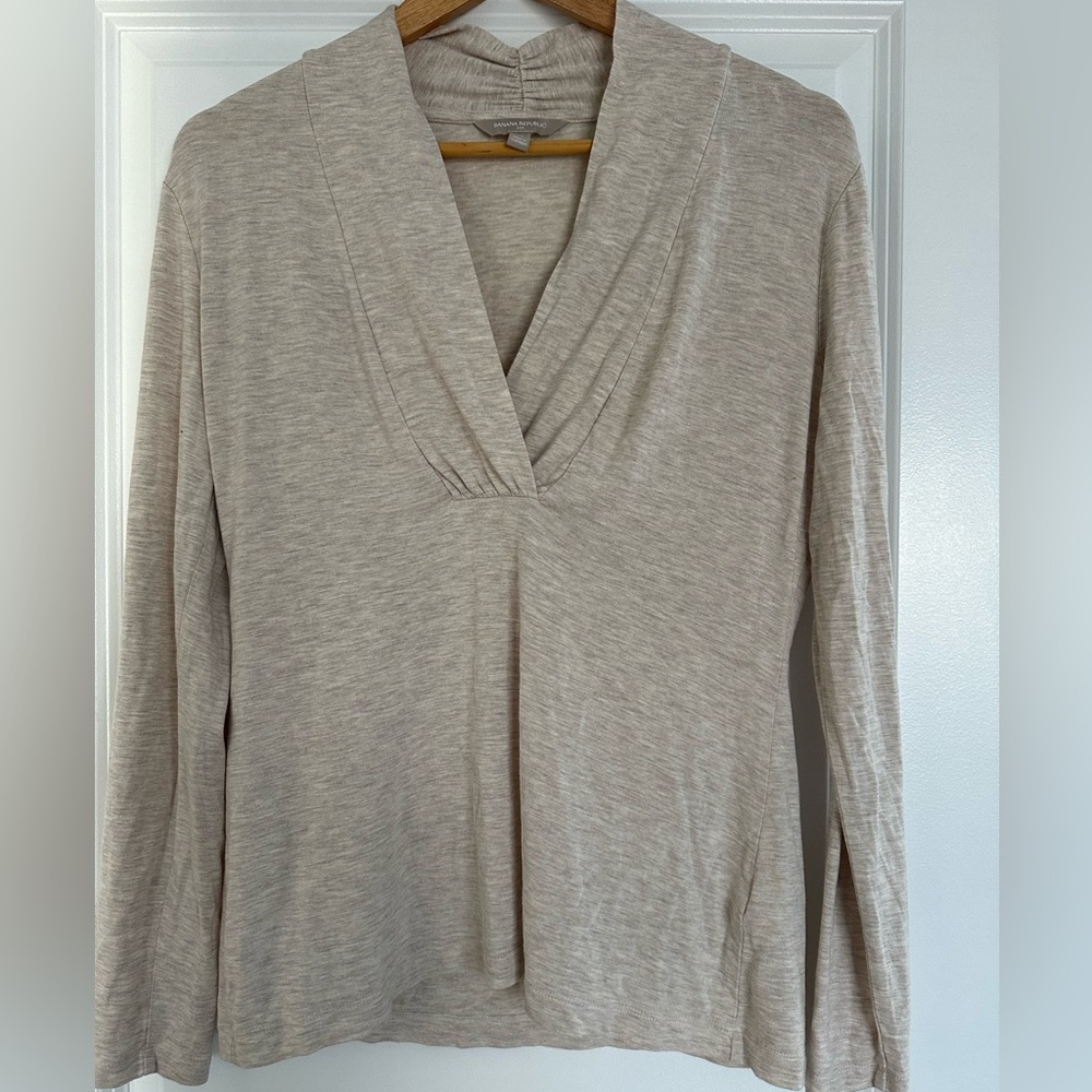 Beige v neck long sleeve with decorative material in the back neck